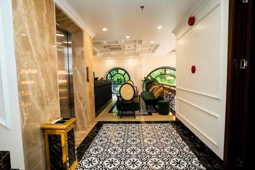 a room with a hallway with chairs and a table at Hotel Trung Duong in Móng Cái