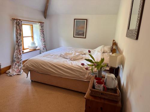 a bedroom with a bed and a window at Lara's House in Balderstone