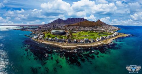 an island in the ocean next to the water at Dawson's Creek in Cape Town
