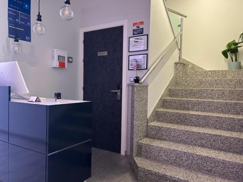 a hallway with a door leading to a staircase at Pension San Anton in Melide