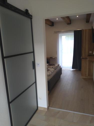 a sliding glass door in a bedroom with a bed at Weingut Thomas Brandl in Strass