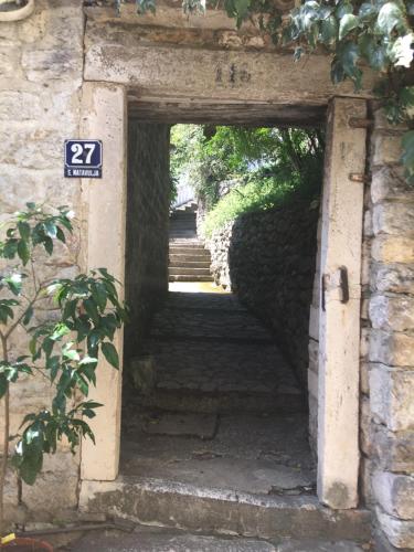 an entrance to a stone building with an open door at Apartment Simo in Herceg-Novi