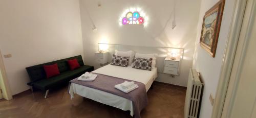 a small bedroom with a bed and a couch at Casa Giuseppina Lecce in Lecce