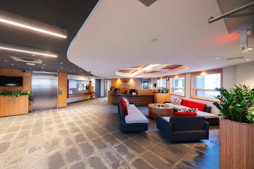 an office lobby with couches and chairs and a table at Residence & Conference Centre - Kingston in Kingston