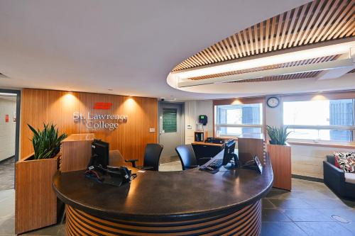 an office cubicle with a desk with two computers at Residence & Conference Centre - Kingston in Kingston