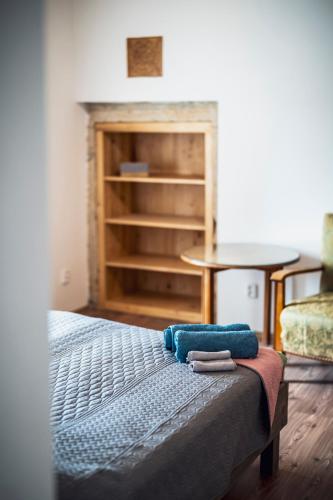 a bedroom with a bed with two towels on it at Dvůr Dolenec in Rohoznice