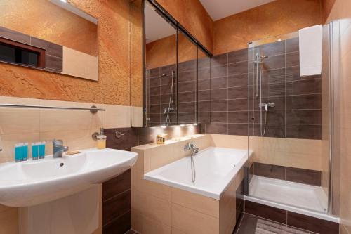 a bathroom with a sink and a shower at Powstańców Śląskich Homely Apartment in Wrocław