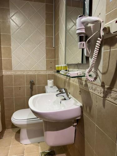 a bathroom with a sink and a toilet at Sky View Hotel, Madinah in Al Madinah