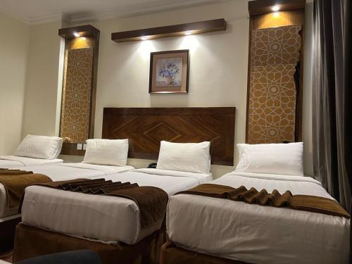 a row of beds in a hotel room at Sky View Hotel, Madinah in Medina