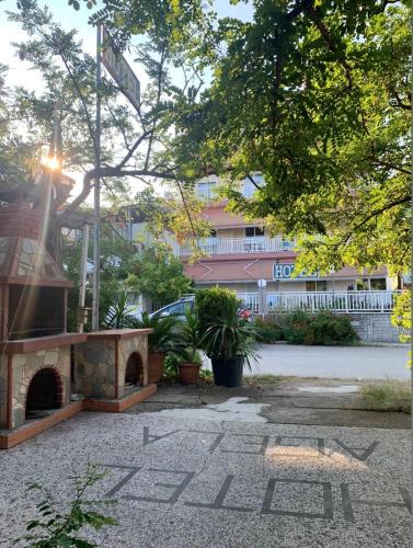 a courtyard with a fire place in front of a building at Hotel Angela in Asprovalta