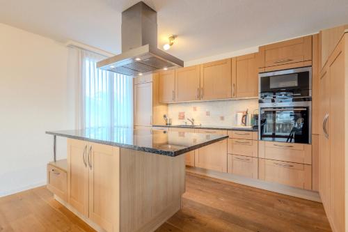 a kitchen with wooden cabinets and a counter top at Chalet Apartments Iseltwald in Iseltwald
