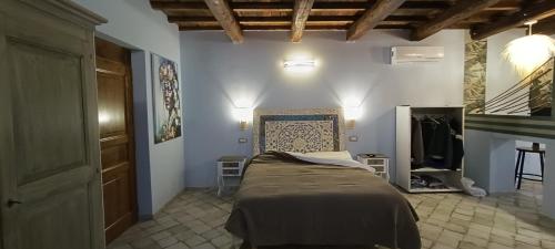 a bedroom with a bed in a room with a staircase at Il Granaio Del Pavone in Nepi