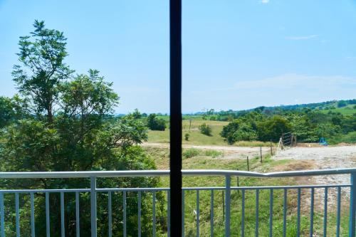 a view of a field from a balcony at Hotel Arbóreo Doradal in Doradal