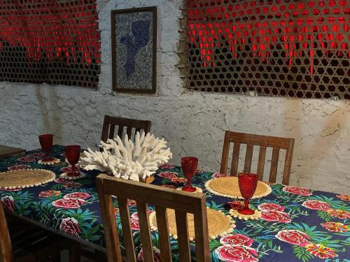 a table with chairs and a table cloth with plates on it at Namahamade Lodge Restaurante & Beach Bar in Mossuril