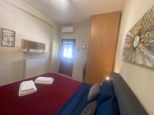a small room with a bed with towels on it at ZoYa ‘s Apartments in Agria