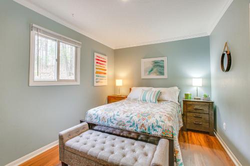 a bedroom with a bed and a dresser and a window at Traverse City Retreat with Deck and Lake Access in Traverse City