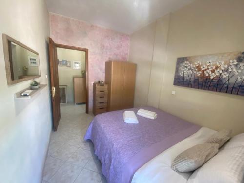 a small bedroom with a bed and a mirror at ZoYa ‘s Apartments in Agria