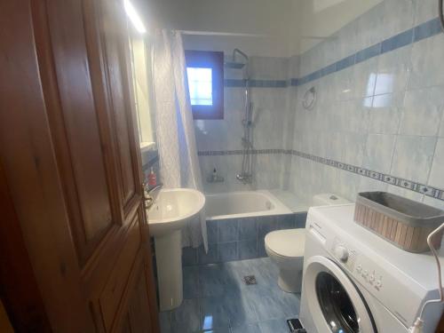 a bathroom with a sink and a toilet and a tub at ZoYa ‘s Apartments in Agria