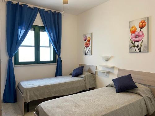 Postel nebo postele na pokoji v ubytování Casa Artemide - Primo piano indipendente con vista mare
