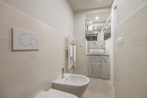 ein weißes Bad mit einem WC und einem Waschbecken in der Unterkunft Il Mezzanino in Siena