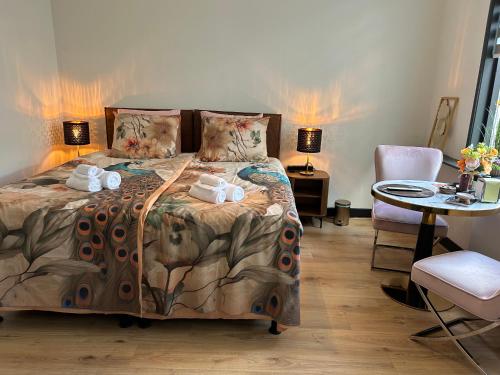 a bedroom with a bed with towels on it at Bed & Breakfast Achter de Haven in Vlissingen