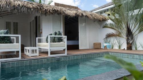 a villa with a swimming pool in front of a house at Preabeach Boutique Hotel & SPA in Prea