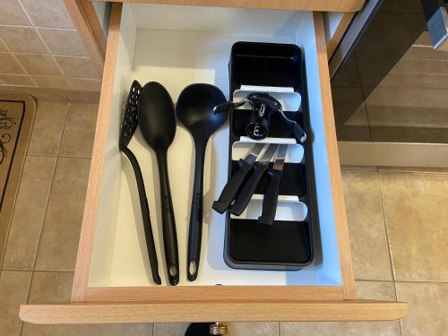 a wooden box with utensils in it at ZoYa ‘s Apartments in Agria