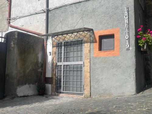 a door with bars on the side of a building at Il laghetto 19 in Capodimonte