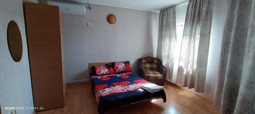 a living room with a couch and a window at Vila Natasa&Sofia in 2 Mai