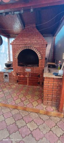 a brick oven in the middle of a room at Vila Natasa&Sofia in 2 Mai