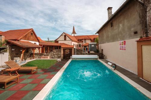 a swimming pool in the backyard of a house at Carolina House in Sighişoara
