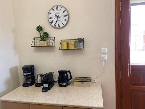 a kitchen counter with a clock on the wall at ZoYa ‘s Apartments in Agria