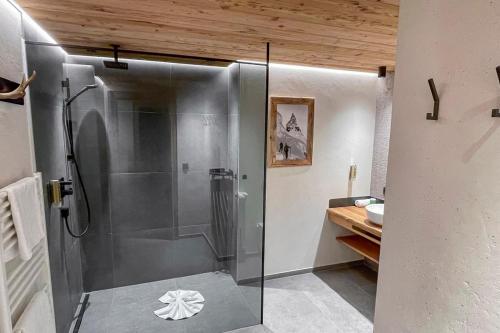 a shower with a glass door in a bathroom at Naturlodge Ladis im Sommer inkl Super Sommer Card in Ladis
