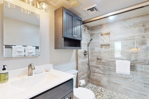 a bathroom with a sink and a toilet and a shower at Bay Creek Villa - 202 in Edisto Beach