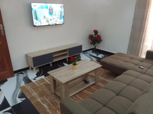 a living room with a couch and a coffee table at Appartement Meublé aux Almadies in Ngor