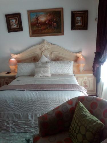 a bedroom with a large bed and a couch at The Royal Princess B&B on Malibongwe Drive in Johannesburg