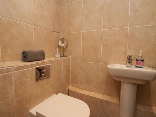 a bathroom with a toilet and a sink at Jara in Bamburgh