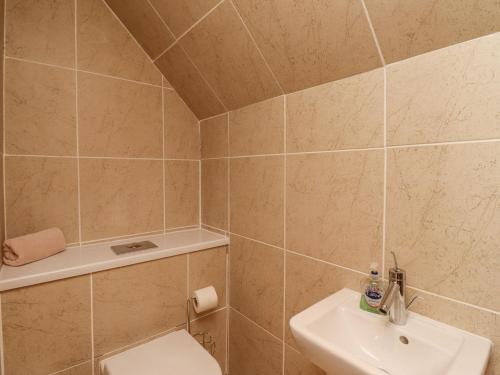 a bathroom with a toilet and a sink at Jara in Bamburgh