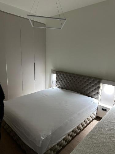 a bedroom with a large bed with a white mattress at Belgrade Waterfront Sole in Sajmište