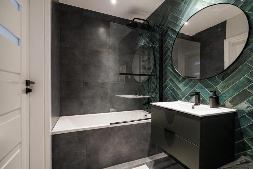 a bathroom with a sink and a mirror at Serenity - Praia Apartments - Polsat Plus Arena Gdańsk in Gdańsk