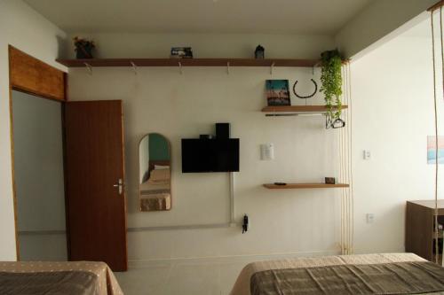 um quarto com duas camas e uma televisão na parede em Sunset Rio no Rio de Janeiro