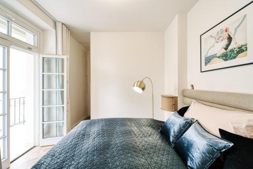 a bedroom with a bed and a large window at AnnaVila in Piešťany