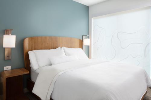 a large white bed in a hotel room at Element Iowa City in Iowa City