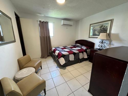 a bedroom with a bed and a chair and a table at Spacious Unit with 5BR, 3BA Perfect for Big Groups, Near Ocean Park Beach in San Juan