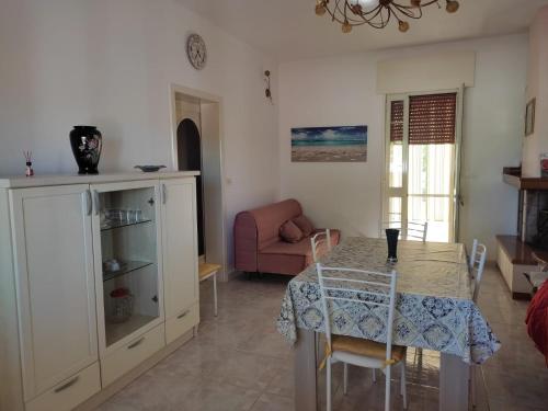 a living room with a table and a chair at La Villetta in Cutrofiano