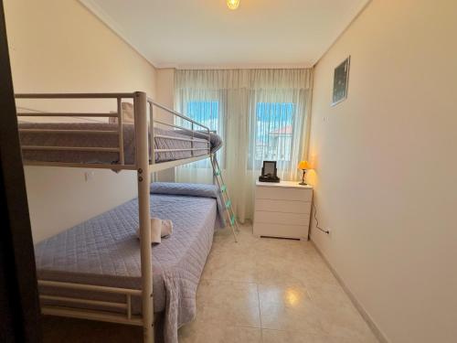 a bedroom with two bunk beds and a window at El Patuco - 6821 in Noja