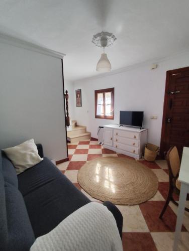 a living room with a couch and a table at Casa Soledad in Vejer de la Frontera