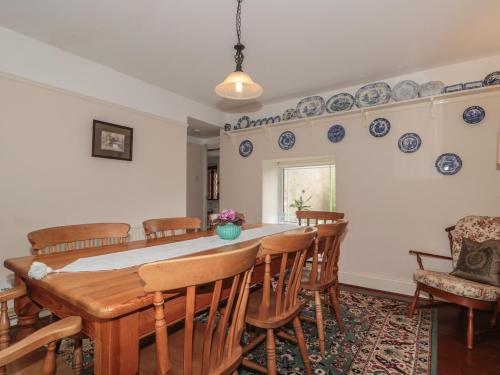 a dining room with a table and chairs at Cathay House in Cheddar