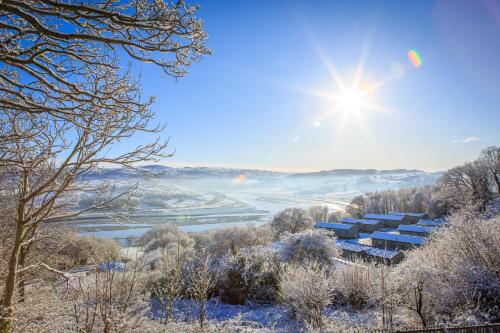 a view of a valley in the snow with the sun at The Manor Boutique Hotel Restaurant and Bar in Conwy