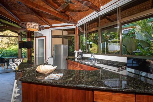 an open kitchen with a large island in a house at Tulemar Resort in Manuel Antonio